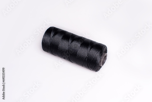 Black thread isolated on white background (ID: 641335499)
