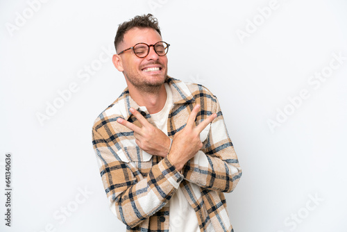 Young caucasian handsome man isolated on white background smiling and showing victory sign