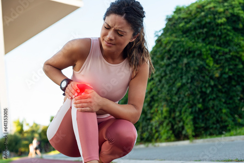 Young fitness woman runner feel pain in her knee