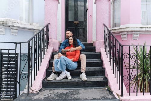 Young Heterosexual Couple Embracing on London Home Steps
