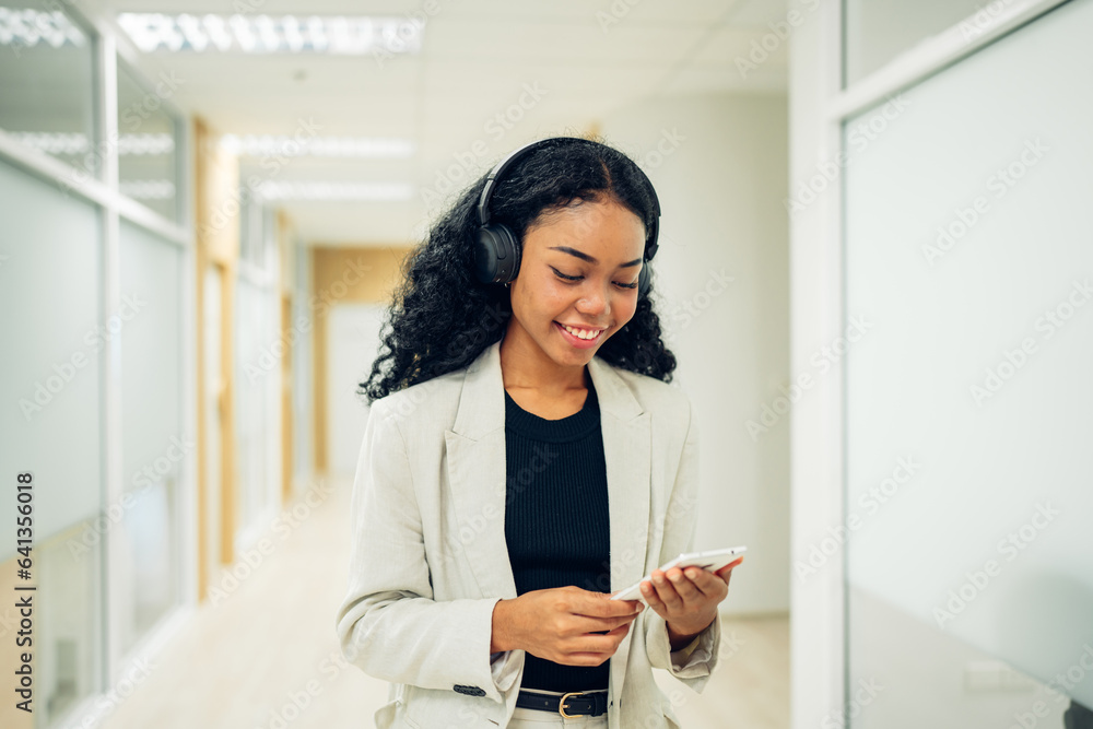 Shot of elegant young business woman smiling and using mobile phone while walking, Copy space. Shot of elegant young business woman smiling and using mobile phone while walking, Copy space.