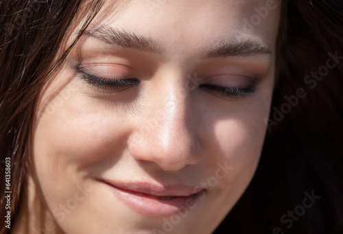 Close-up portrait of a beautiful young woman with eyes closed © schankz