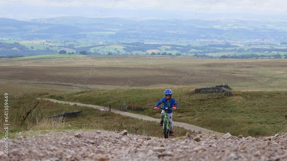 A Boy Rides a Bicycle in the Countryside With a Beautiful View On a Background A Boy Rides a Bicycle in the Countryside With a Beautiful View On a Background