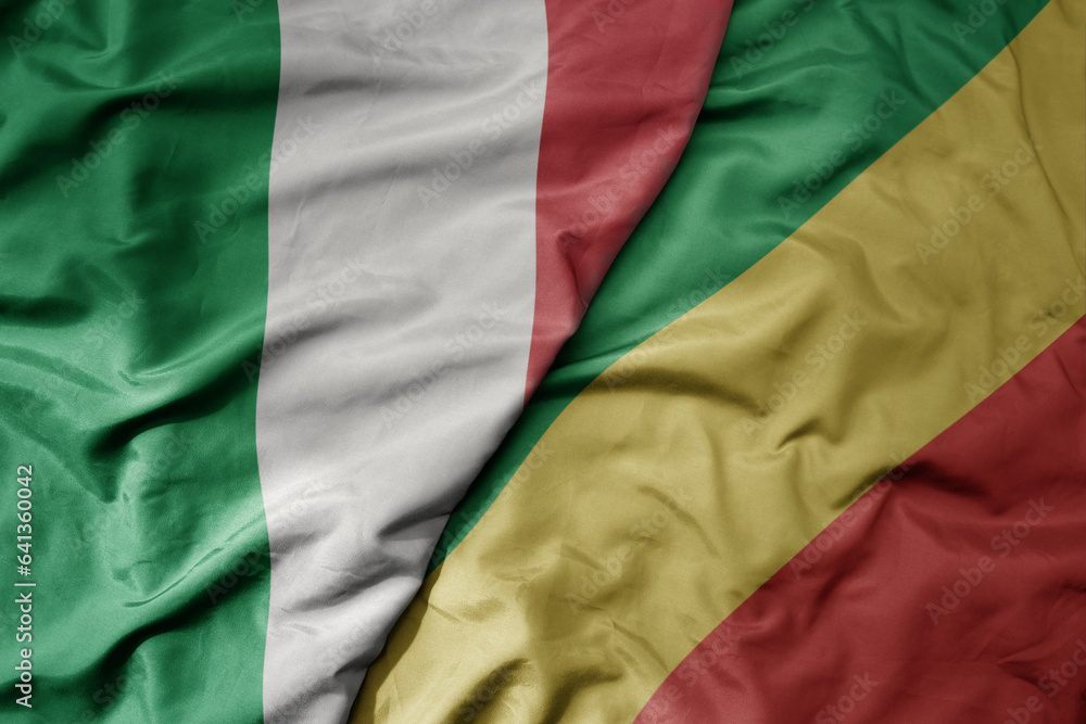 big waving national colorful flag of italy and national flag of republic of the congo .