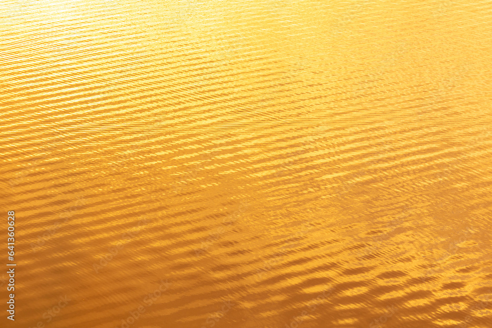 Water ripples in golden tones. Abstract background and texture for design Water ripples in golden tones. Abstract background and texture for design