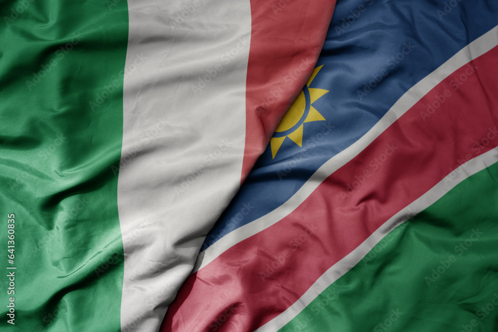 big waving national colorful flag of italy and national flag of namibia .