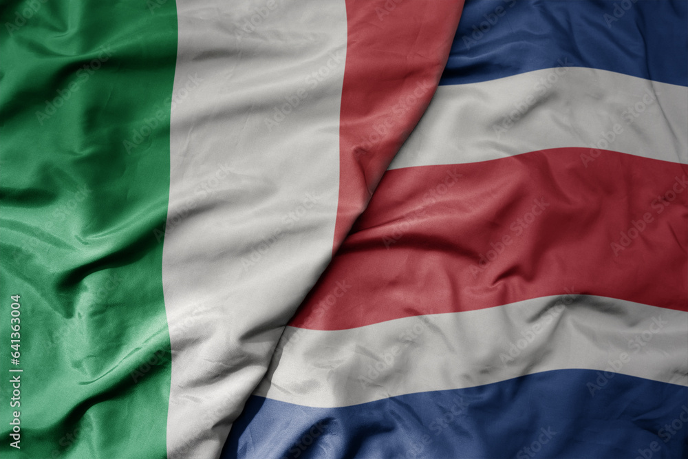 big waving national colorful flag of italy and national flag of costa rica .