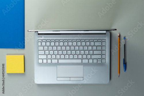 Cenital view of a laptop on a desk with pen, pencil, folder , business concept, 