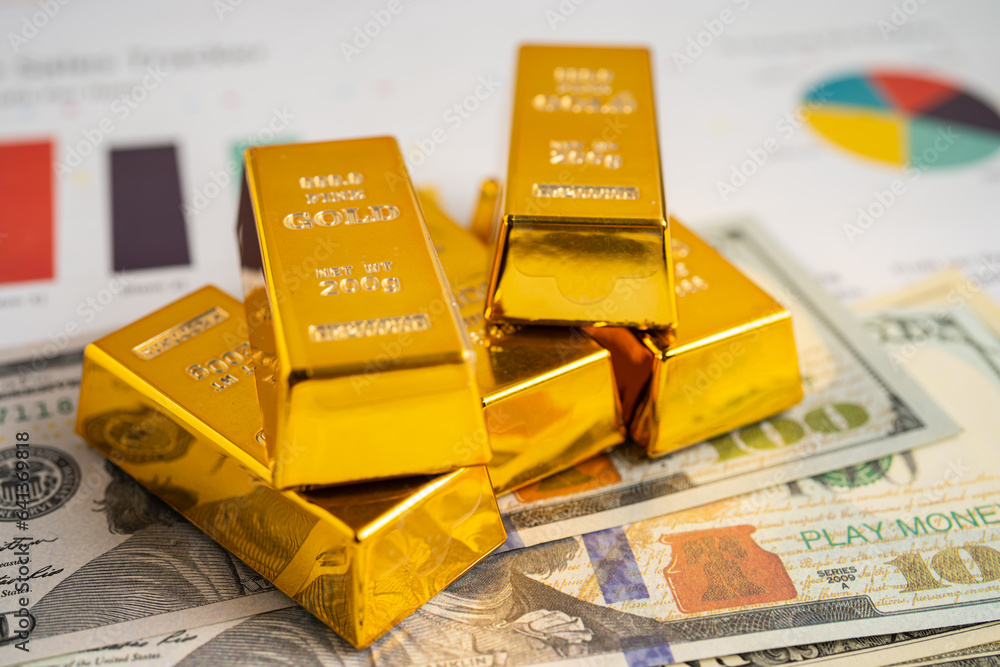 Gold bar on US dollar banknotes money and graph, economy finance exchange trade investment concept. Gold bar on US dollar banknotes money and graph, economy finance exchange trade investment concept.