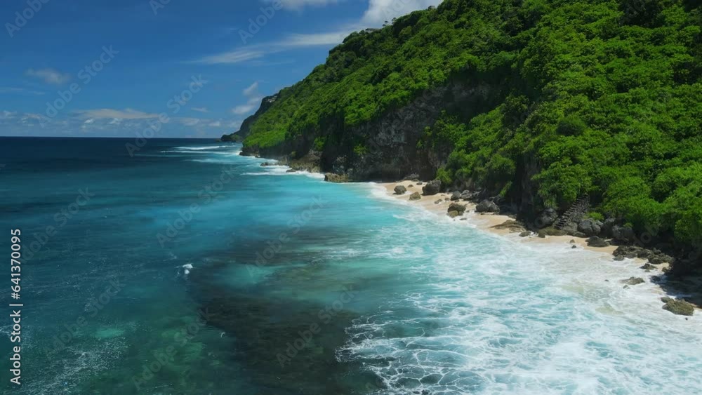 Aerial view of ocean with hidden tropical beach under cliffs. Aerial view of ocean with hidden tropical beach under cliffs.