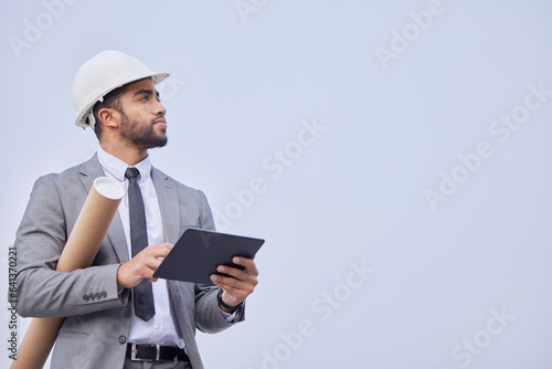 Man, architect and thinking with tablet on mockup in construction planning on a studio background. Person, engineer or contractor with technology, blueprint or project plan for architecture on space
