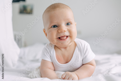 Infant baby lying on tummy propped up on arms
