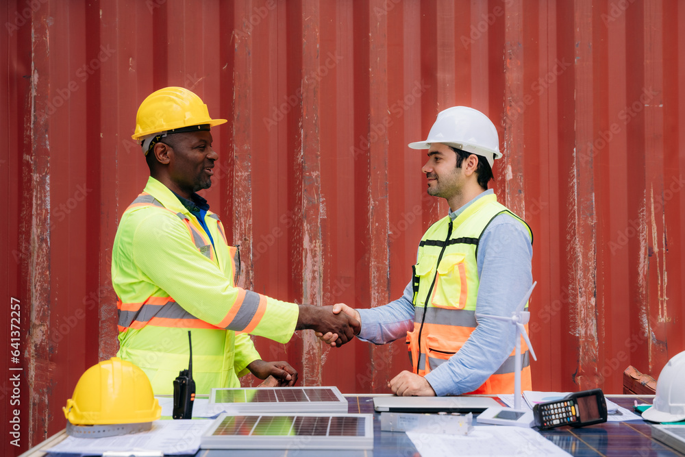Team worker stack hand and shake hands to show success work at Container cargo harbor. Logistics concept inside the shipping, import, and export industries. Team worker stack hand and shake hands to show success work at Container cargo harbor. Logistics concept inside the shipping, import, and export industries.