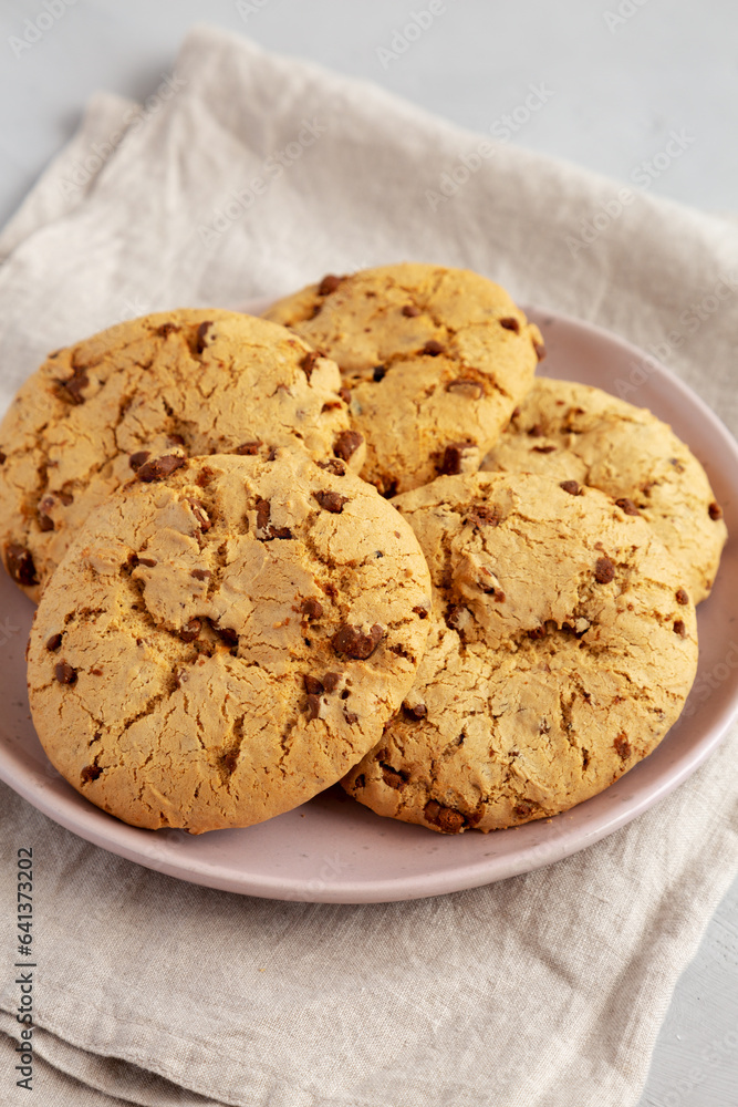 Homemade Cookies with Milk Chocolate Chunks on a Plate, side view. Homemade Cookies with Milk Chocolate Chunks on a Plate, side view.