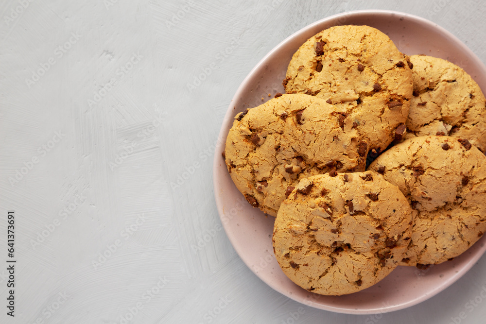 Homemade Cookies with Milk Chocolate Chunks on a Plate, top view. Flat lay, overhead, from above. Copy space. Homemade Cookies with Milk Chocolate Chunks on a Plate, top view. Flat lay, overhead, from above. Copy space.