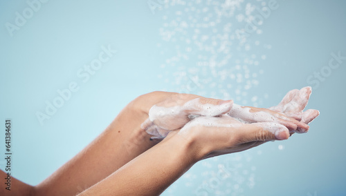 Cleaning, hands and woman with soap and water in studio, blue background and healthcare or skincare mockup. Model, closeup or washing skin for clean, hygiene and protection from bacteria or virus