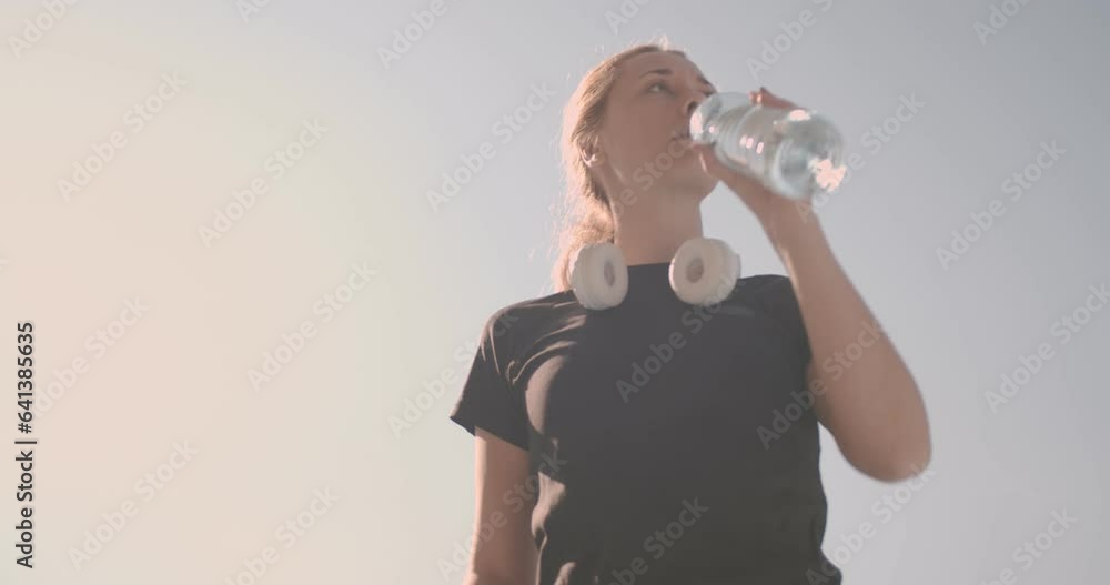 Girl drinking water in summertime Girl drinking water in summertime