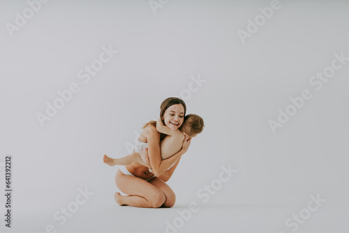 Beautiful woman holding baby boy, motherhood and pregnancy concept