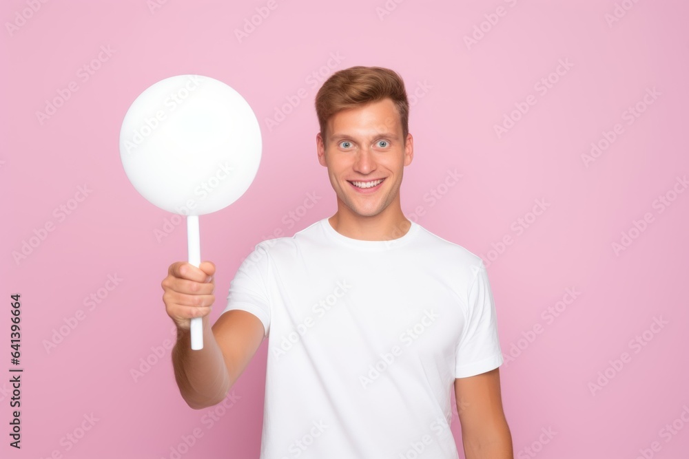 Portrait of a Fictional Man Holding a Plain White Blank Sign. Isolated on a Pink Background. Generative AI. Portrait of a Fictional Man Holding a Plain White Blank Sign. Isolated on a Pink Background. Generative AI.