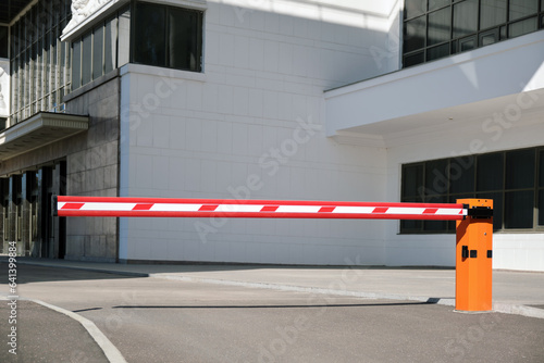 Fototapeta Naklejka Na Ścianę i Meble -  Automatic barrier at the entrance to the parking lot near the public building.