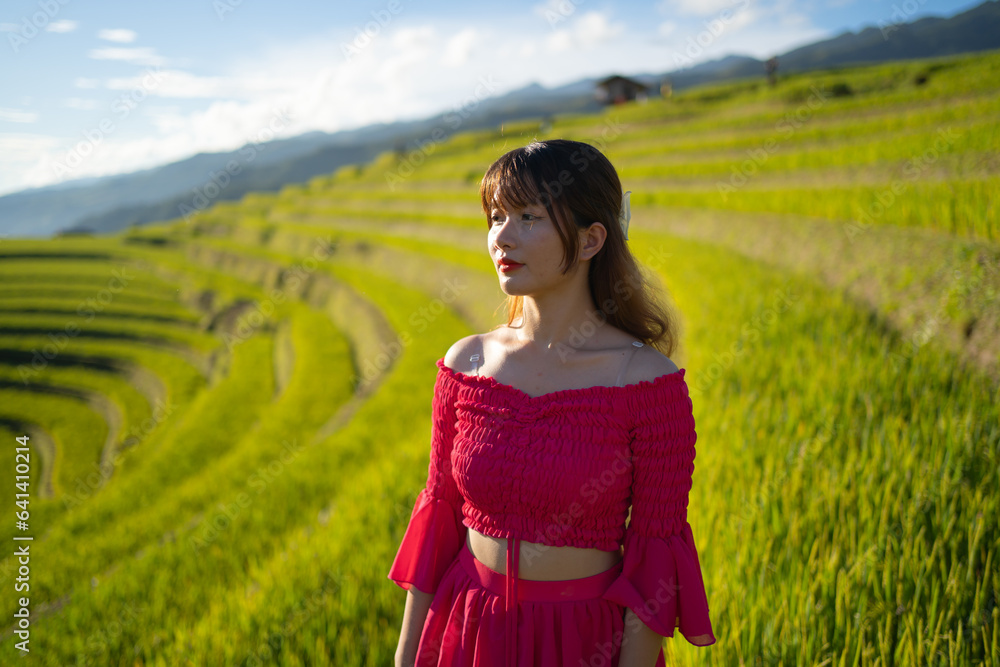 A farmer woman with fresh paddy rice terraces, green agricultural fields in countryside or rural area of Mu Cang Chai, mountain hills valley in Asia, Vietnam. Nature landscape. People lifestyle. A farmer woman with fresh paddy rice terraces, green agricultural fields in countryside or rural area of Mu Cang Chai, mountain hills valley in Asia, Vietnam. Nature landscape. People lifestyle.