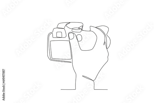 A hand adjusts the focus of the camera. World photography day one-line drawing
