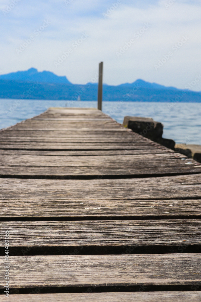 Fototapeta premium Wooden pier overlooking the Alps and Lake Geneva in Switzerland
