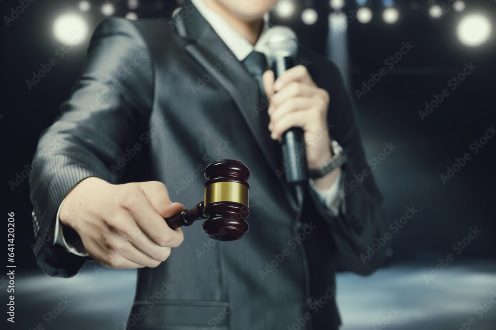 The shareholder holds an auction with a microphone in his hands. The shareholder holds an auction with a microphone in his hands.