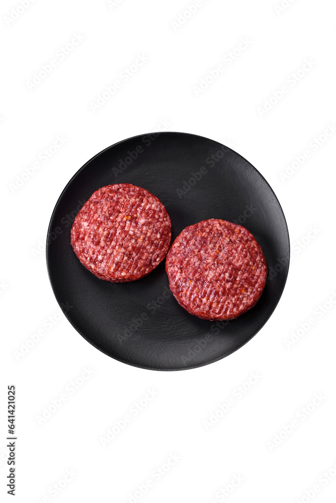 Fresh raw ground beef burger patty with salt and spices Fresh raw ground beef burger patty with salt and spices