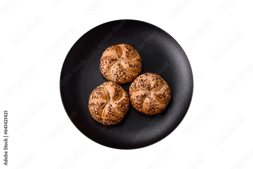 Delicious freshly baked crispy bun or kaiser roll with sesame seeds Delicious freshly baked crispy bun or kaiser roll with sesame seeds