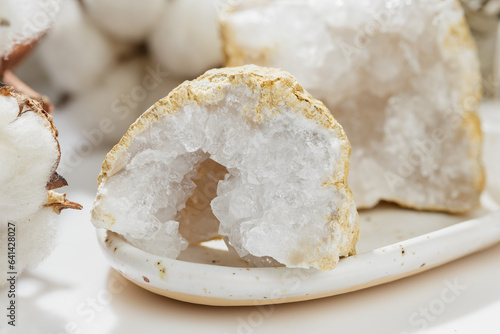 Open Cracked Pure Quartz Crystals Geode on the Table photo