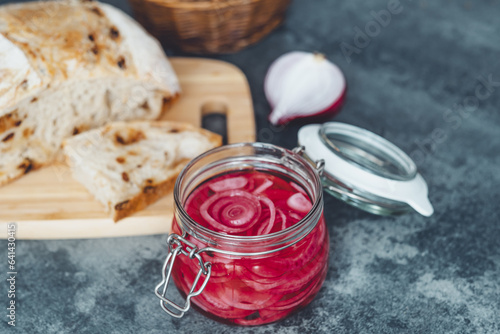 Pickled red onions with slices of homemade bread. Healthy organic food. top view.