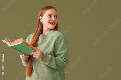 Young woman reading book on...