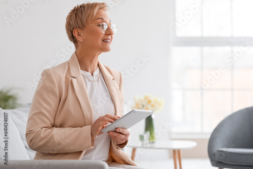 Mature psychologist working...
