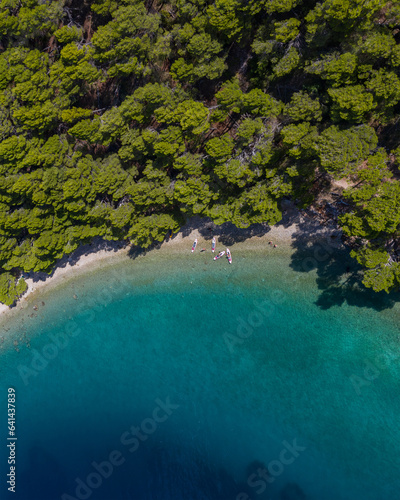 beach with boats and people on the emerald sea aerial view, Makarska riviera in Dalmatia, Croatia