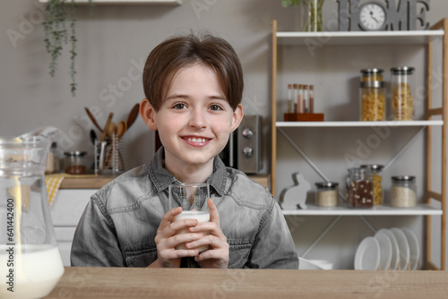 Happy little boy with glass...