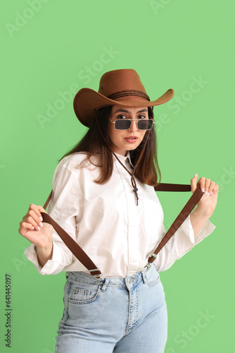 Beautiful cowgirl on green ...