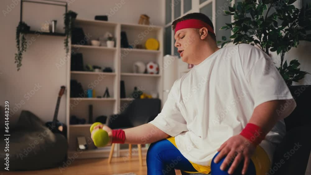 Confident overweight man training at home, trying to lose weight, improvement Confident overweight man training at home, trying to lose weight, improvement