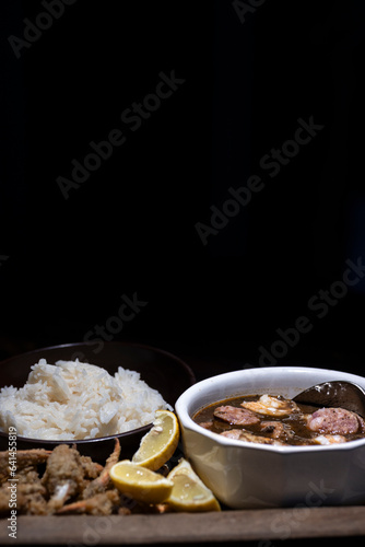 Seafood gumbo with rice and crab fingers. photo