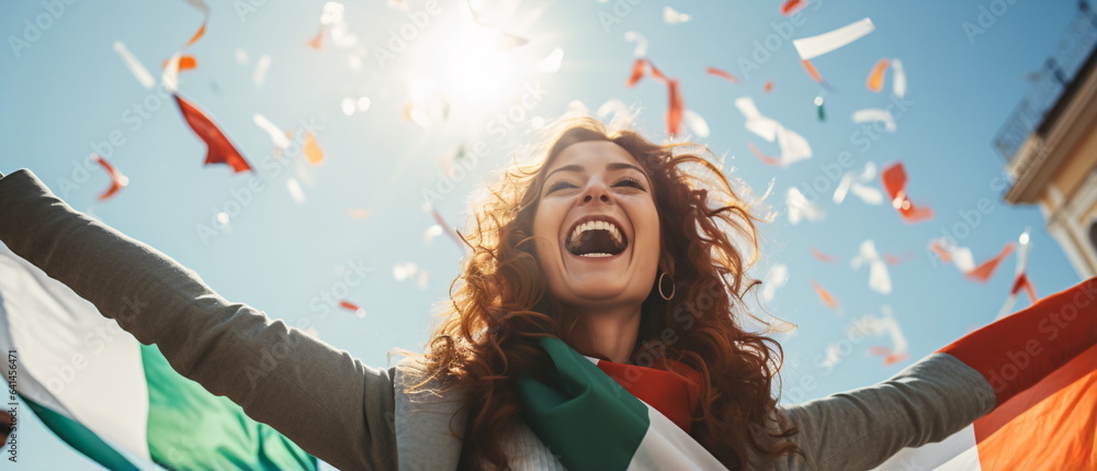 Obraz premium Portrait of pretty and happy Italian woman standing with smile, in front of Italy flags, shouting, celebrating victory or success. Generative ai