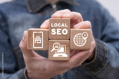 Canvastavla Man holding wooden cubes with icons and inscription: LOCAL SEO