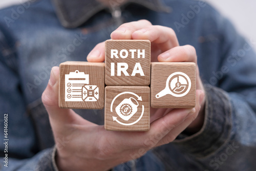 Man holding wooden cubes with icons and inscription: ROTH IRA. Concept of Roth IRA Individual Retirement Account. Roth IRA retirement plan.