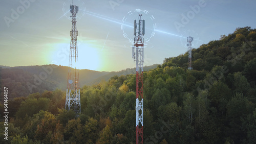 Aerial view of 5G Telecommunication Towers Cellular Network Antenna Signal Waves during sunset between green mountains