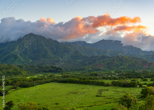 Mountains of the Na Pali mountain range above Hanalei valley in Kauai. Taken just before sunset with the sun lighting clouds photo