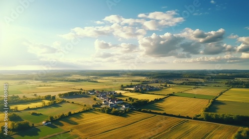 Drone Photography, flying over a serene and peaceful countryside, a patchwork of fields and meadows, farmhouses dotting the landscape, a scene that embodies the charm of rural living