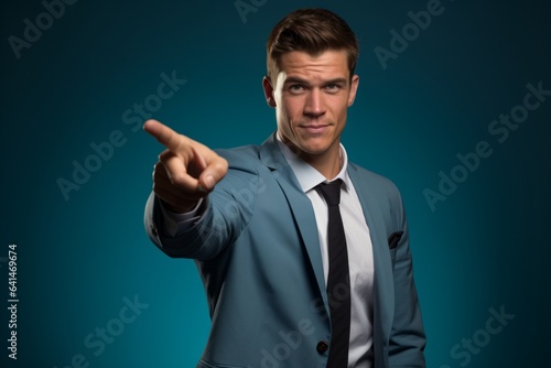 A businessman pointing his finger at the viewer