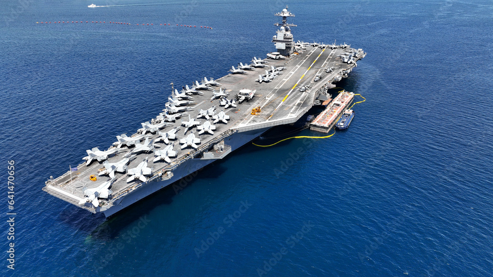 Aerial drone photo of latest technology nuclear powered aircraft carrier USS Gerald Ford anchored in deep blue open ocean sea