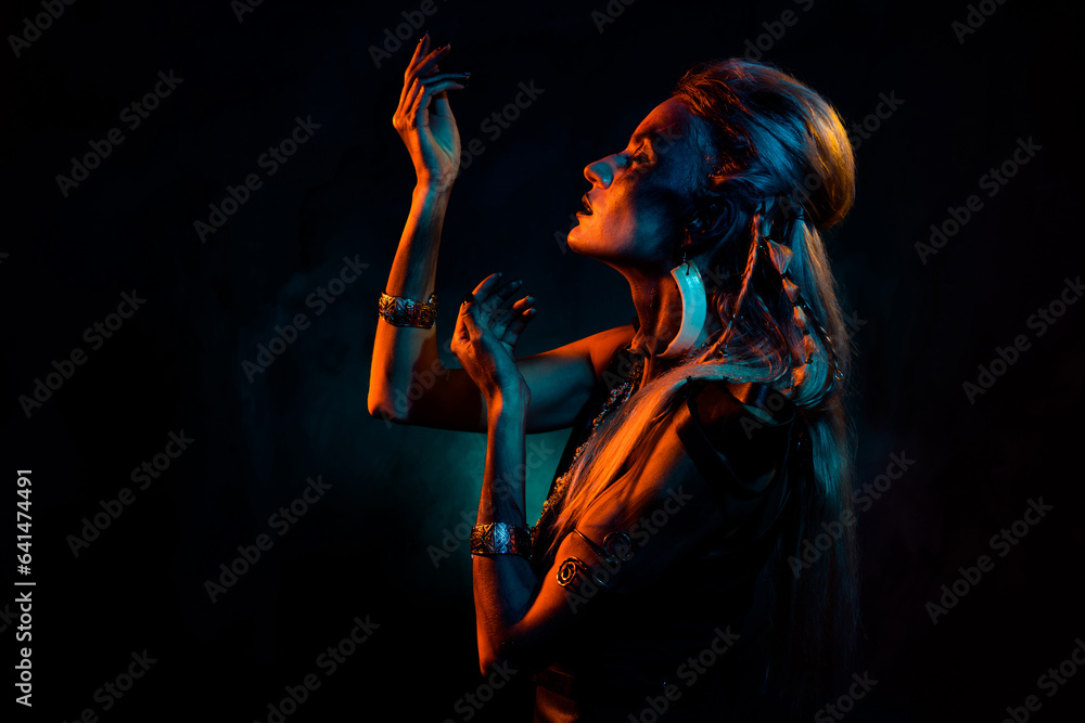 Photo of praying dreamy mystic woman wear gothic valkyrie costume being in trance isolated orange color background