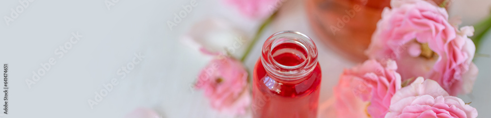 Premium skin care beauty treatment with pink rose petals. Plant-based pure organic ingredients in cosmetics. Jar of body or face moisturiser, lotion. Flower extract, natural youth anti-age elixir Premium skin care beauty treatment with pink rose petals. Plant-based pure organic ingredients in cosmetics. Jar of body or face moisturiser, lotion. Flower extract, natural youth anti-age elixir