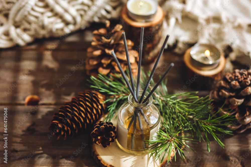 Home aromatherapy with pine cedar oil extracts, essential oil, extract, essence on wooden table. Cozy home atmosphere, natural decor and fragrance. Relaxation, mediation. Apartment design, candles Home aromatherapy with pine cedar oil extracts, essential oil, extract, essence on wooden table. Cozy home atmosphere, natural decor and fragrance. Relaxation, mediation. Apartment design, candles